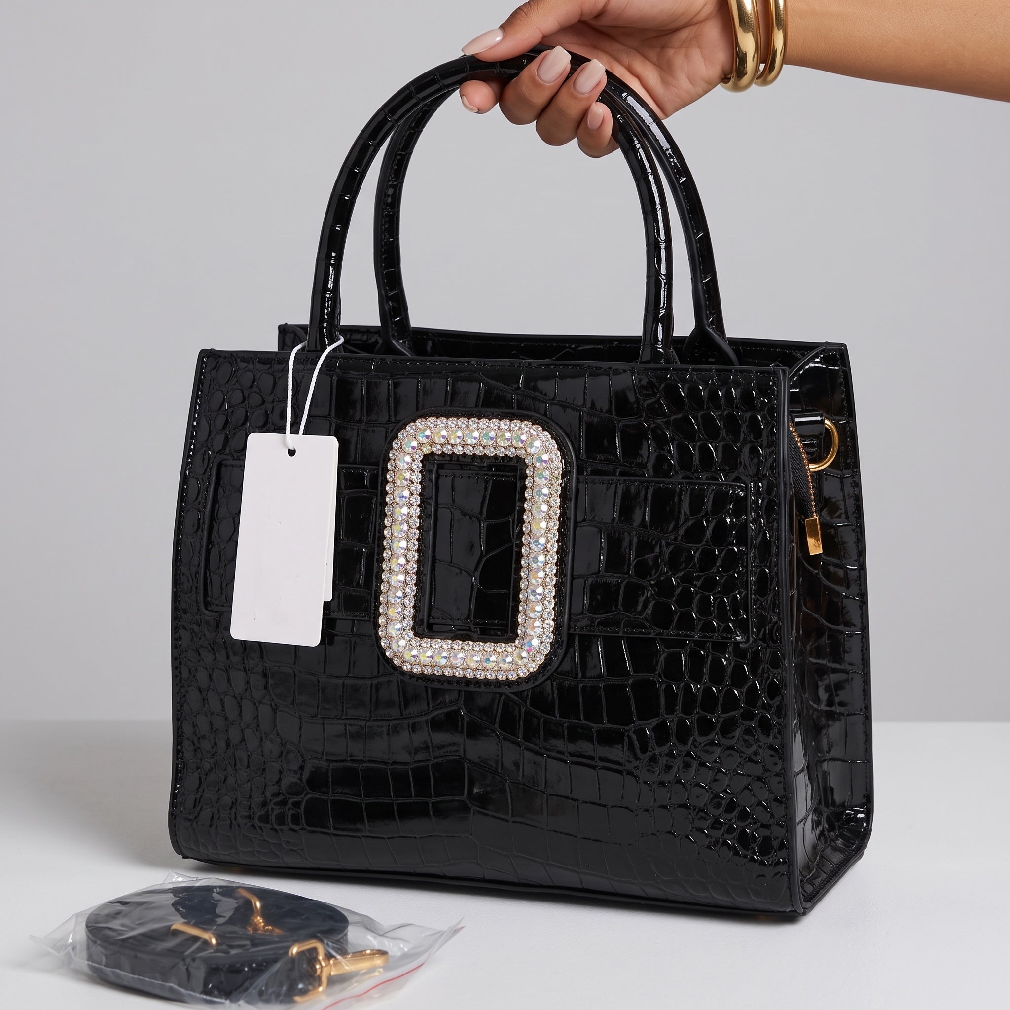 Black croc-effect patent tote bag with large crystal buckle and round top handles