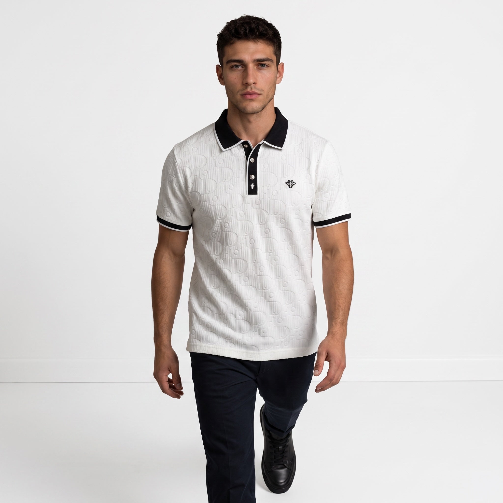 White short-sleeve polo with embossed monogram and black collar