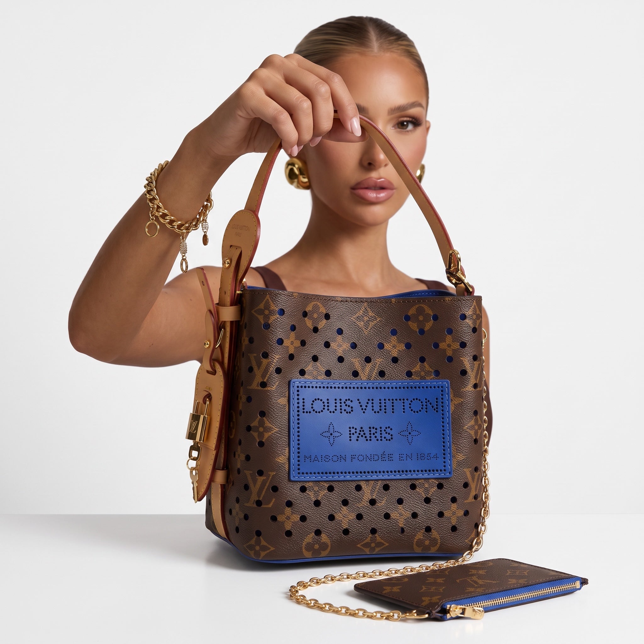 Louis Vuitton monogram bucket bag with blue perforated patch and matching pouch