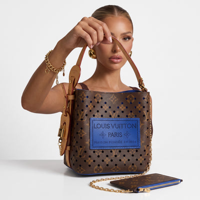 Louis Vuitton monogram bucket bag with blue perforated patch and matching pouch