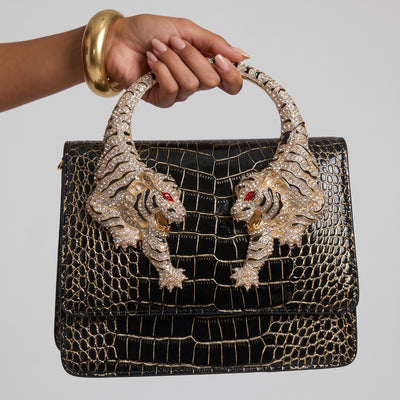 black croc-effect top-handle bag with gold tiger-head circular handle and crystal detail