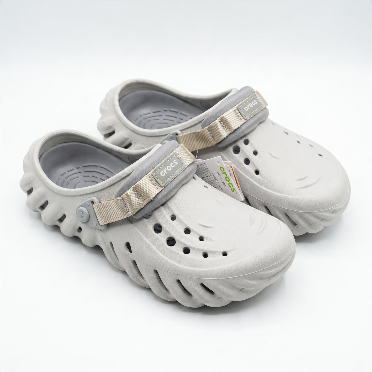 Pair of oyster grey Crocs classic clogs with strap and vent holes