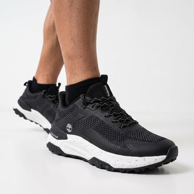 Black Timberland low-top trail sneakers with speckled white midsole