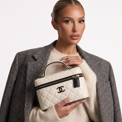 Chanel cream quilted vanity case with black trim and gold CC logo