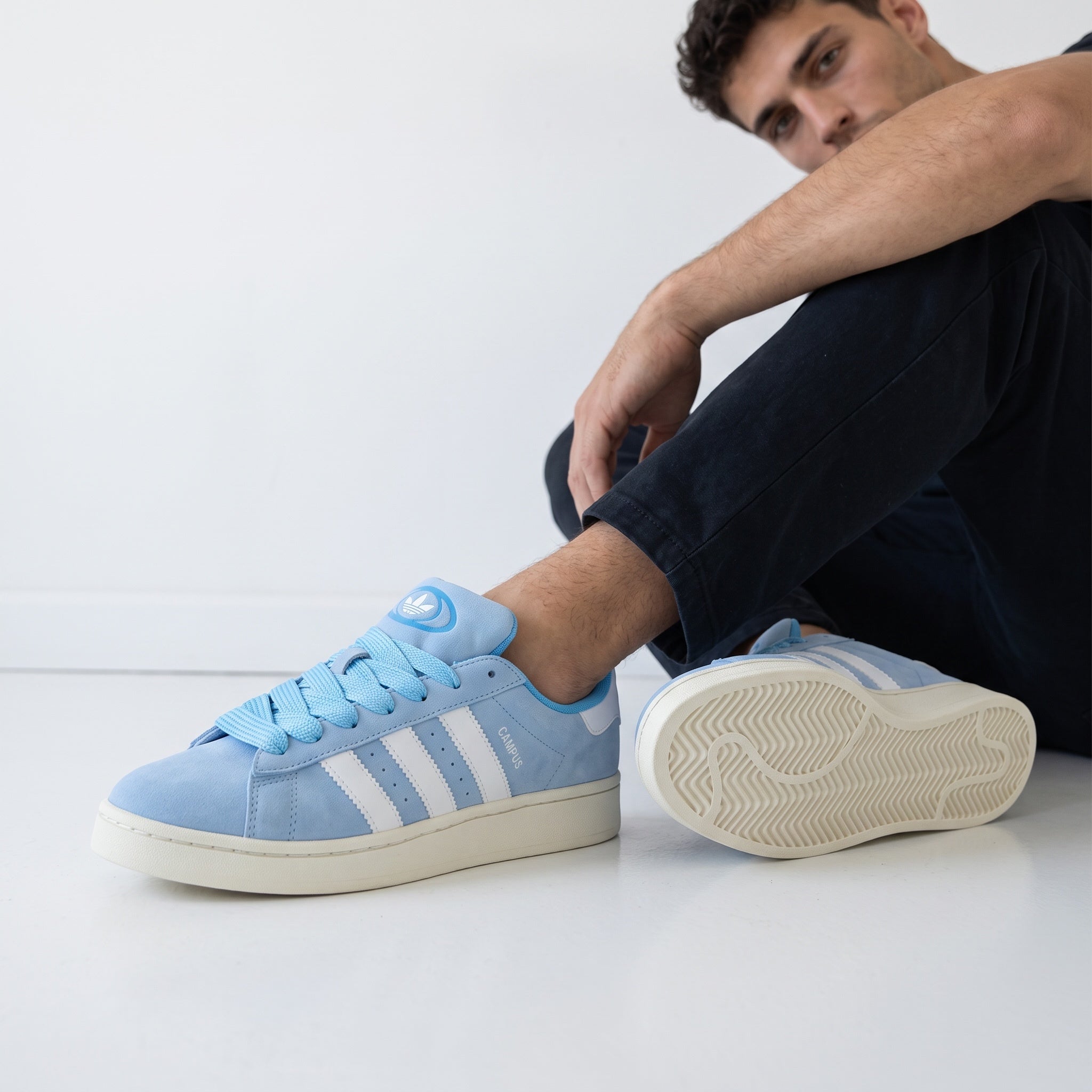 Light blue Adidas Campus low sneakers with white stripes and cream sole