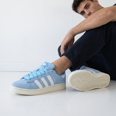 Light blue Adidas Campus low sneakers with white stripes and cream sole
