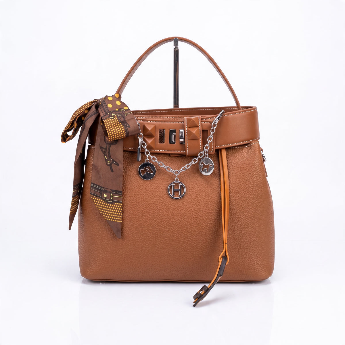 Tan pebbled leather Hermès-style tote with top handle, silver charm chain and tied scarf
