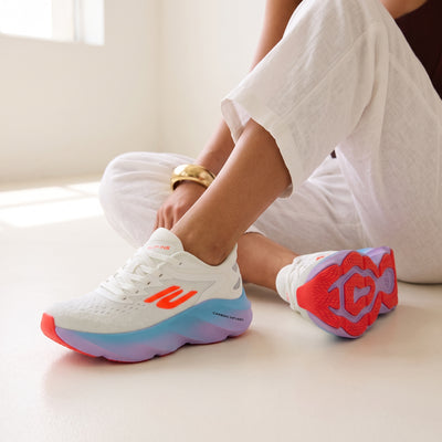 white Skechers-style sneakers with blue-purple gradient sole and neon orange accents