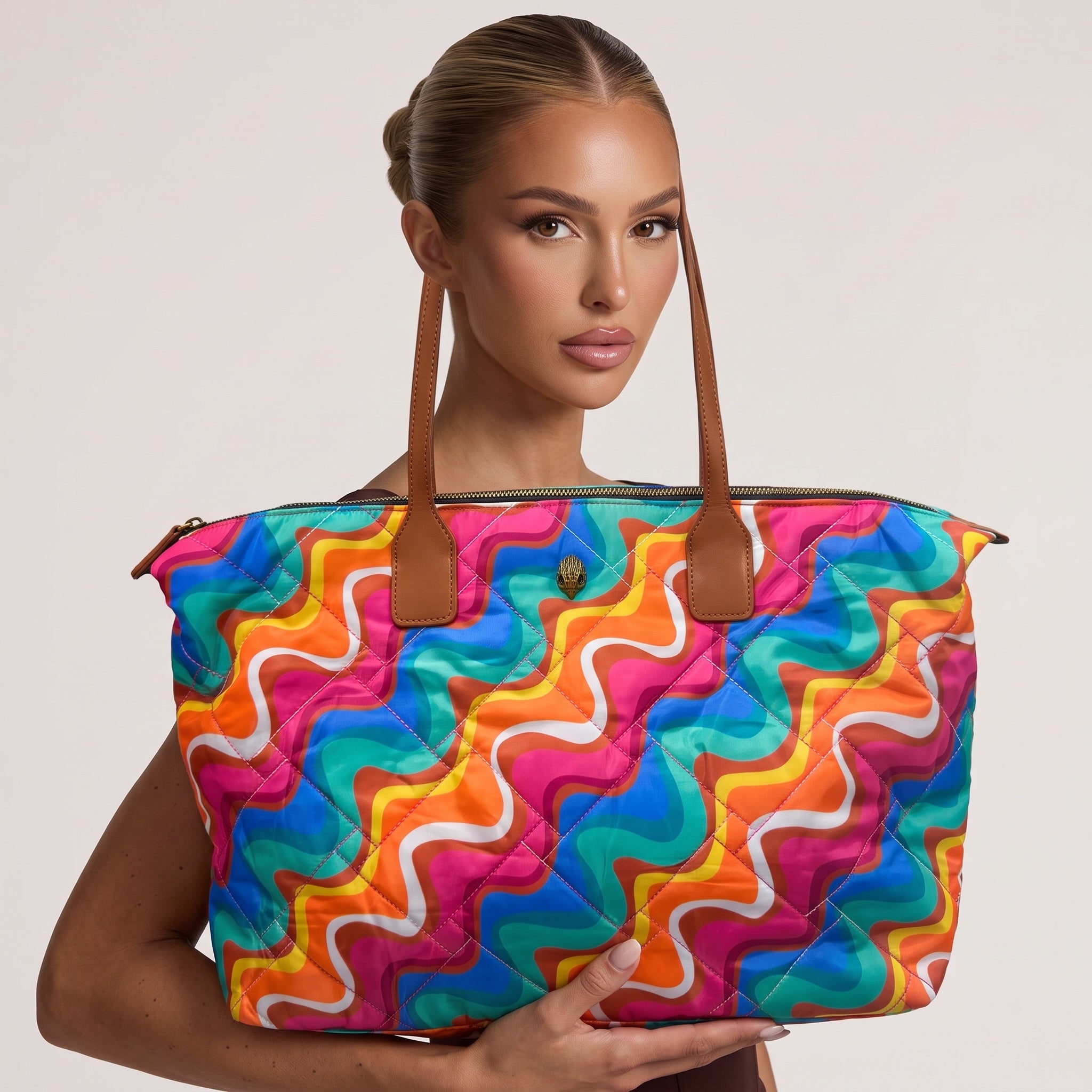 colorful quilted tote bag with brown handles and swirl print