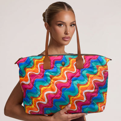 colorful quilted tote bag with brown handles and swirl print