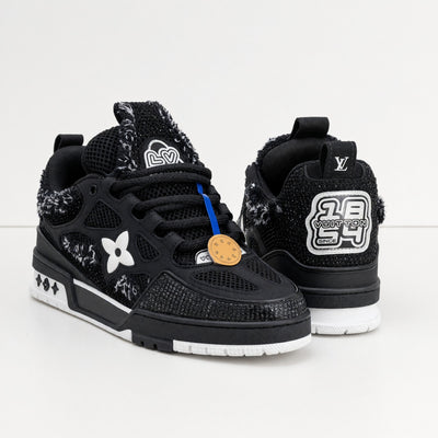 pair of black Louis Vuitton trainers with textured panels and LV logo