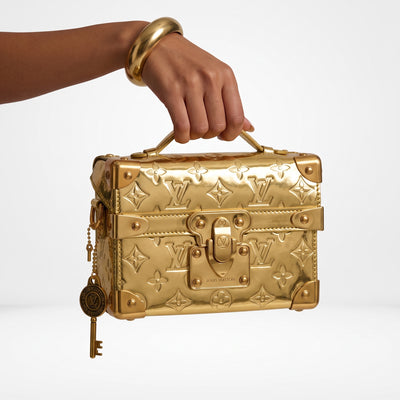 Gold Louis Vuitton Petite Malle mini trunk bag with top handle and embossed monogram