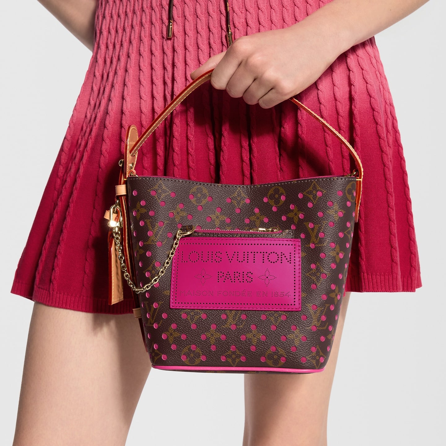 Louis Vuitton brown monogram bucket bag with pink perforations and natural leather handle