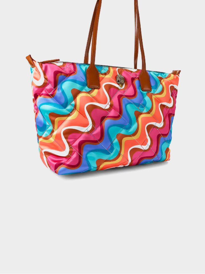 colorful quilted tote bag with brown handles and swirl print