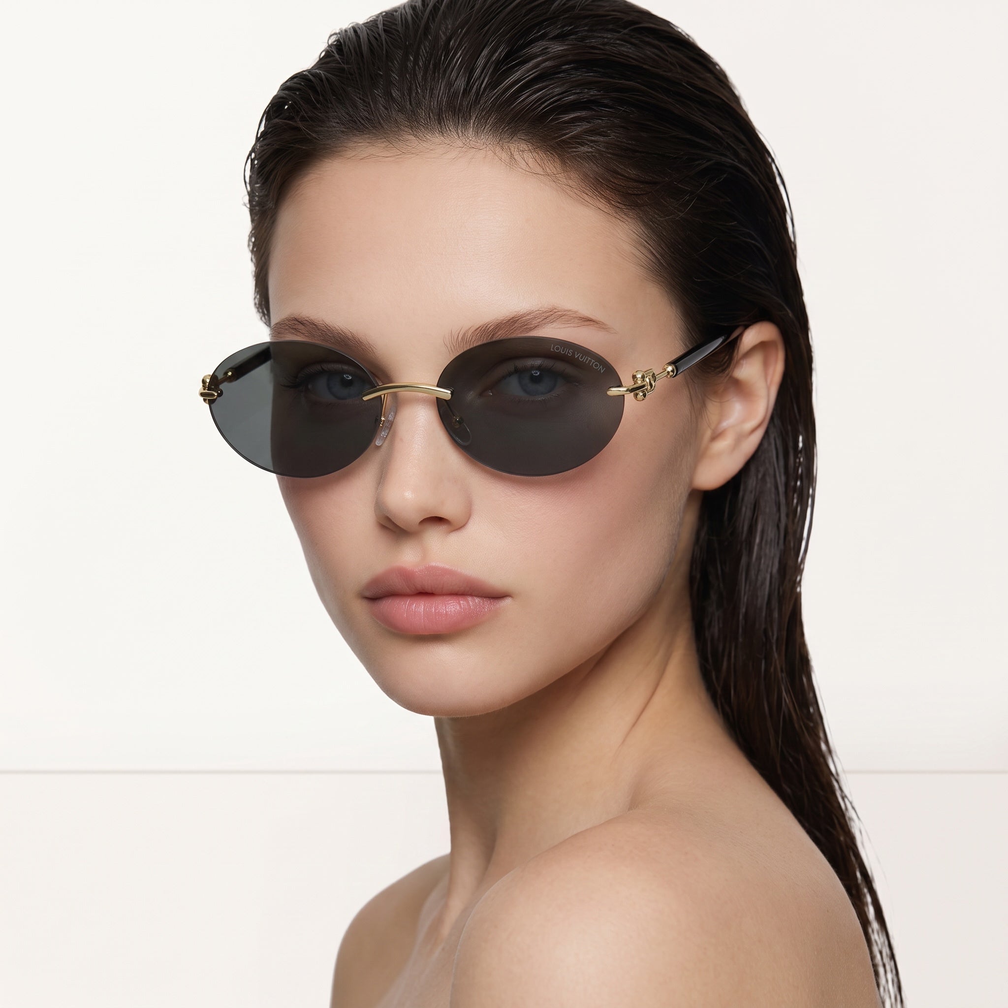 round Louis Vuitton sunglasses with dark lenses and gold bridge