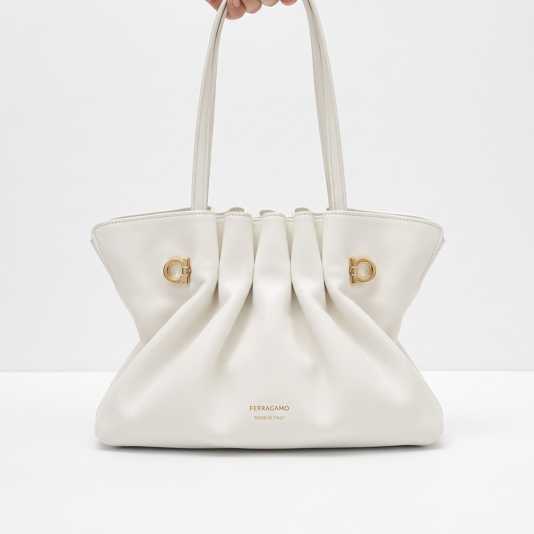 white Ferragamo pleated tote with gold logo hardware and double handles