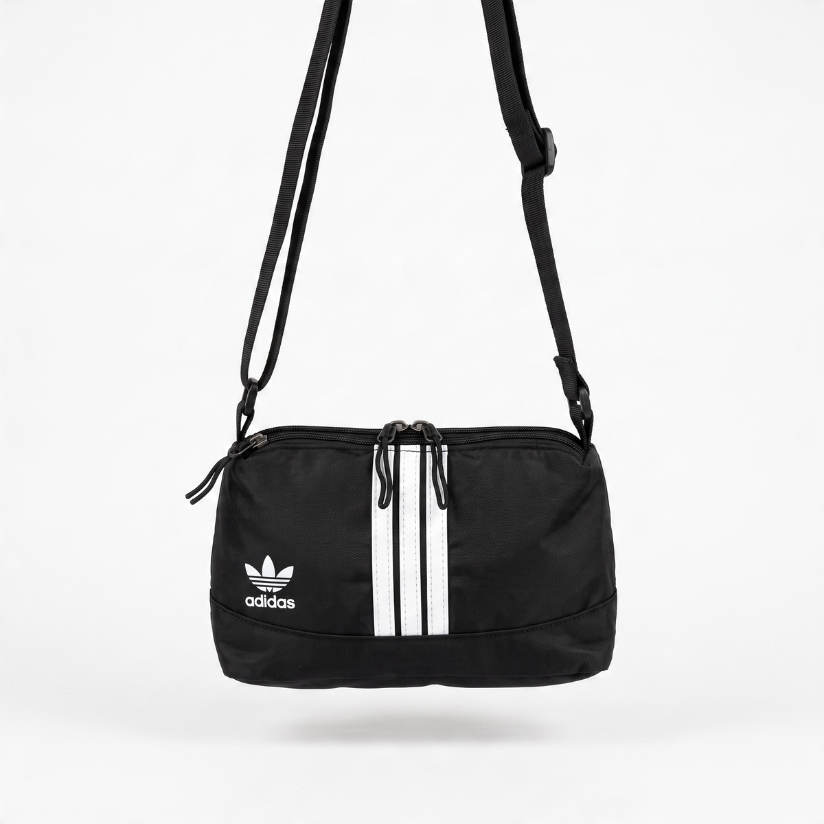 black adidas crossbody bag with white stripes and trefoil logo