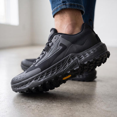Altra black trail running shoes with Vibram outsole shown on feet