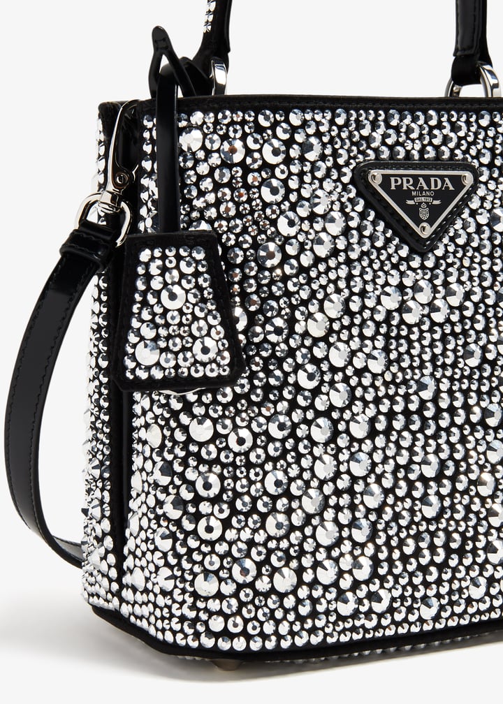 Prada black bucket bag covered in crystals with top handle and shoulder strap