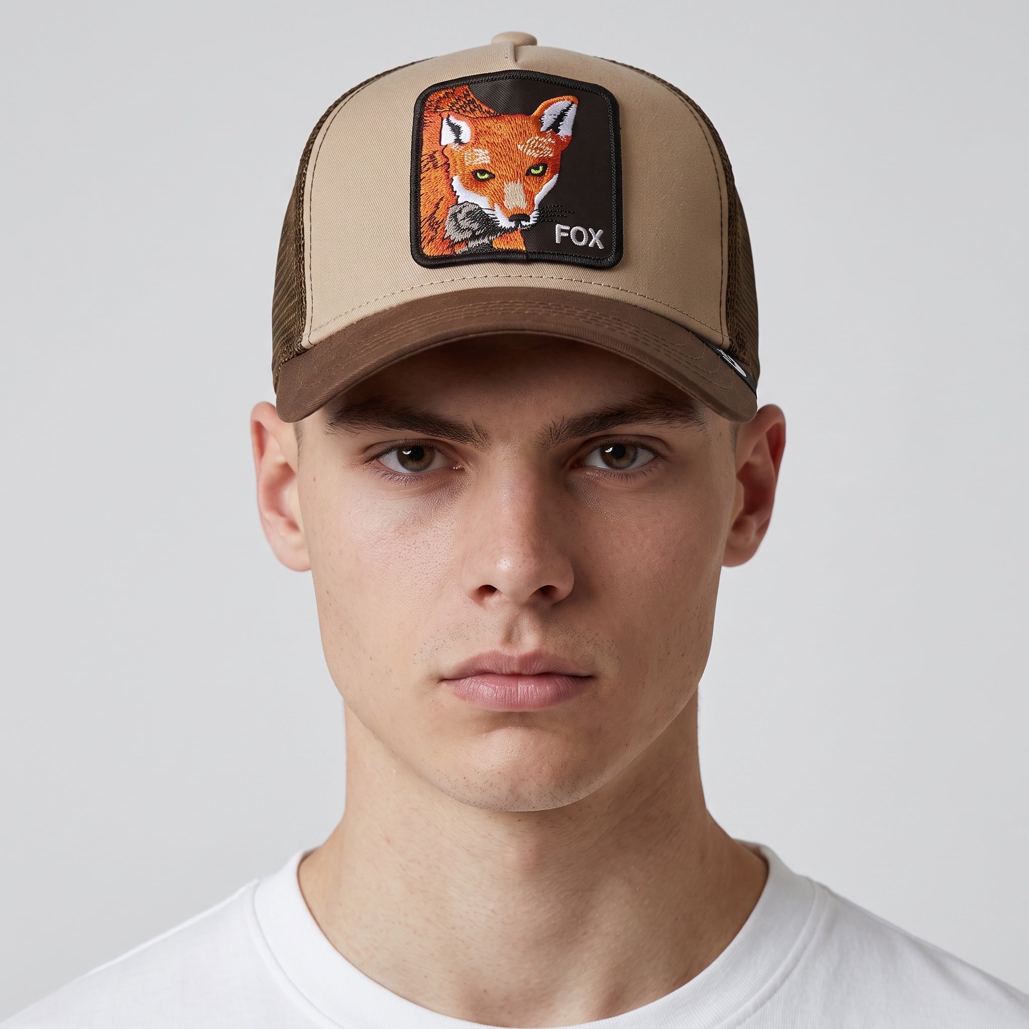 Tan and brown trucker cap with embroidered fox patch on front