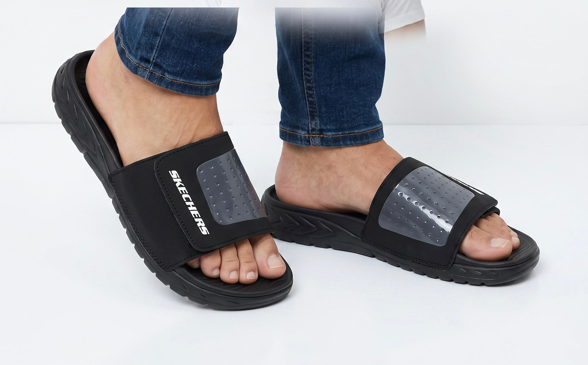 Black Skechers slide sandals with adjustable strap and Skechers logo