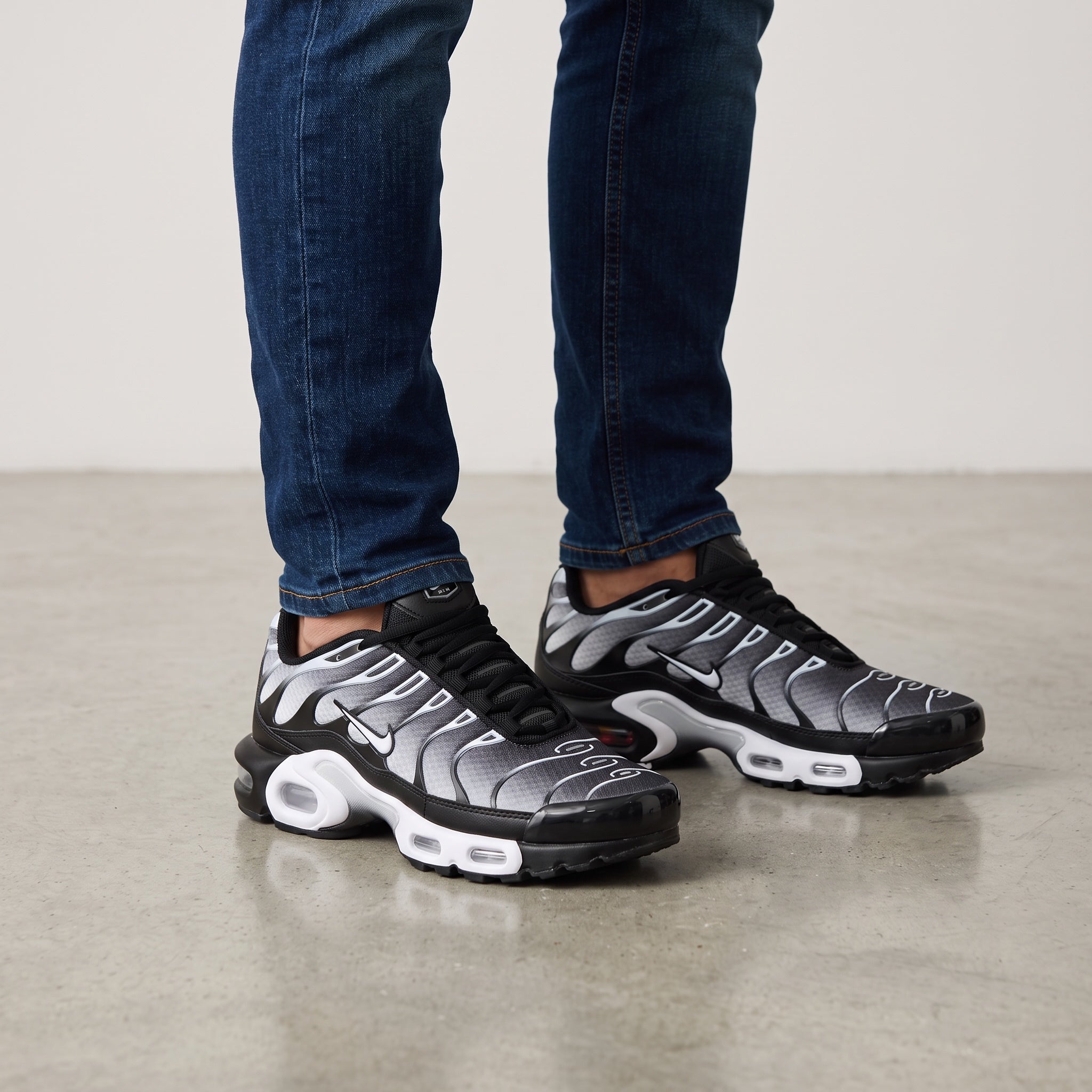 Nike Air Max Plus Tuned black gradient sneakers with visible Tuned Air pods