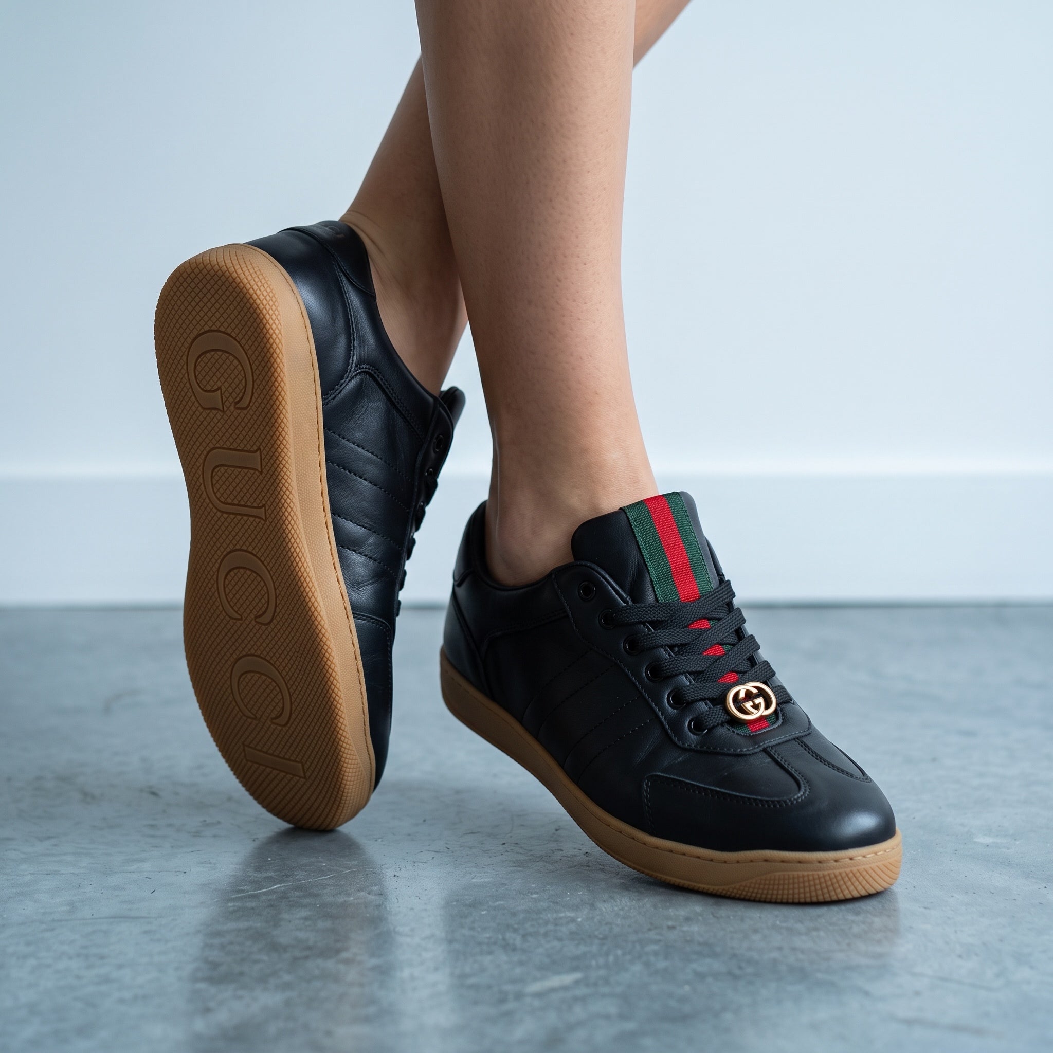 black Gucci Ace sneakers with green red web and gold GG on gum sole
