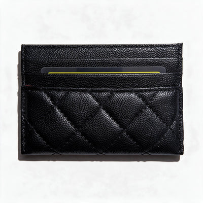 Black quilted Chanel card holder with silver CC logo and card slots