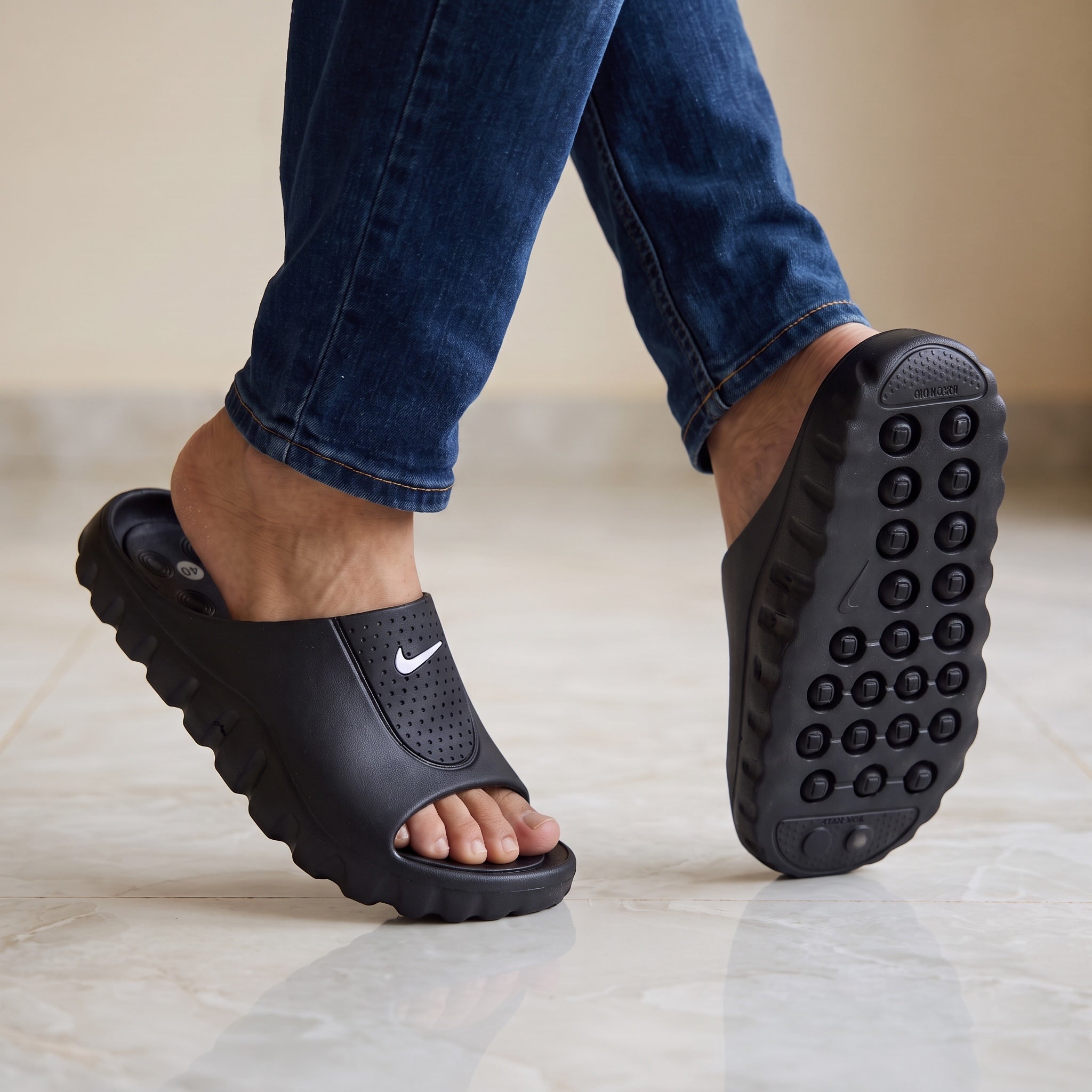 black Nike slip-on slide with white swoosh and sculpted sole