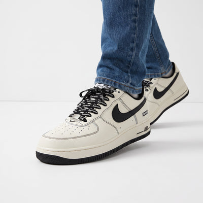 Nike Air Force 1 Low white with black swoosh and Supreme-branded laces