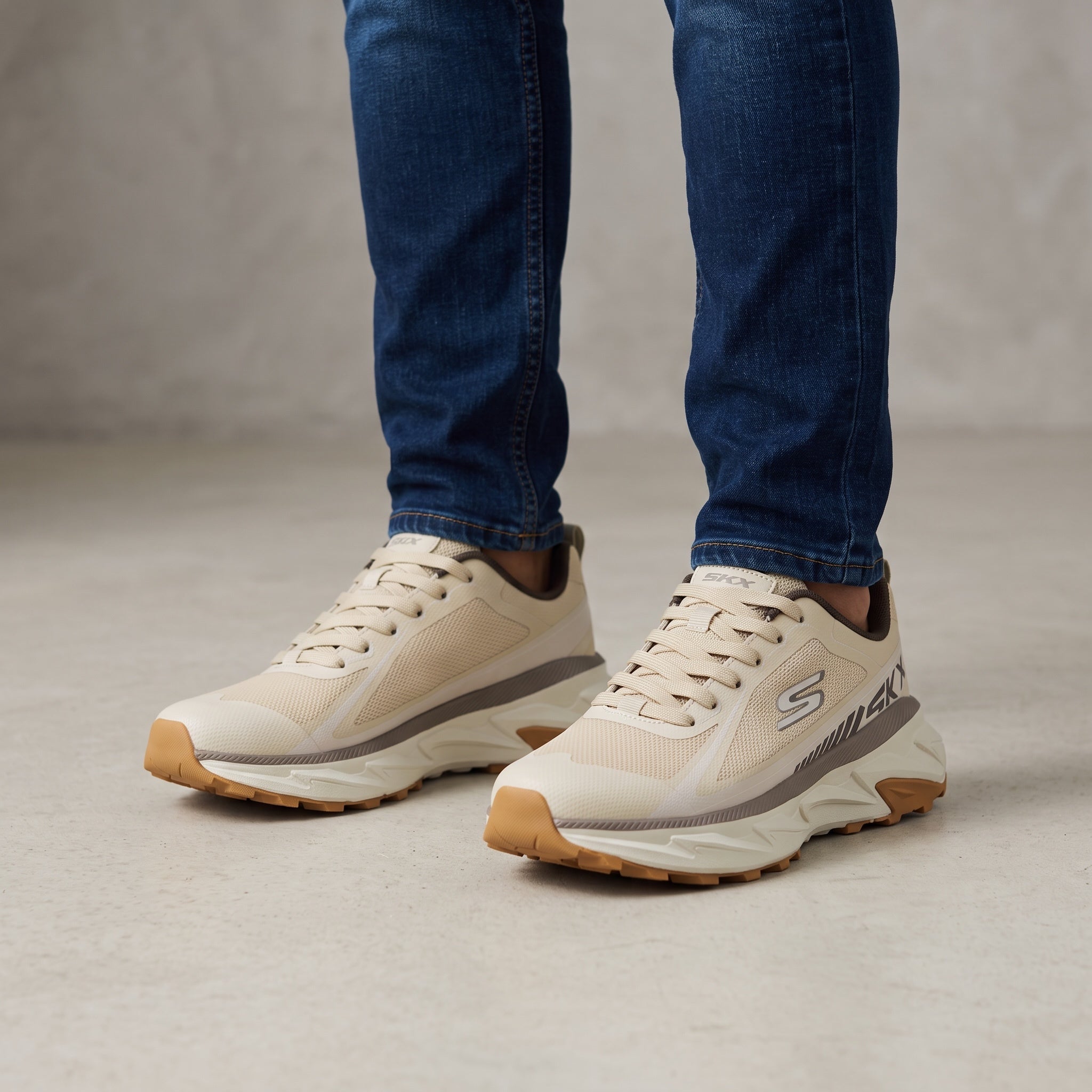 Beige Skechers chunky athletic sneaker with gum outsole and visible side logo