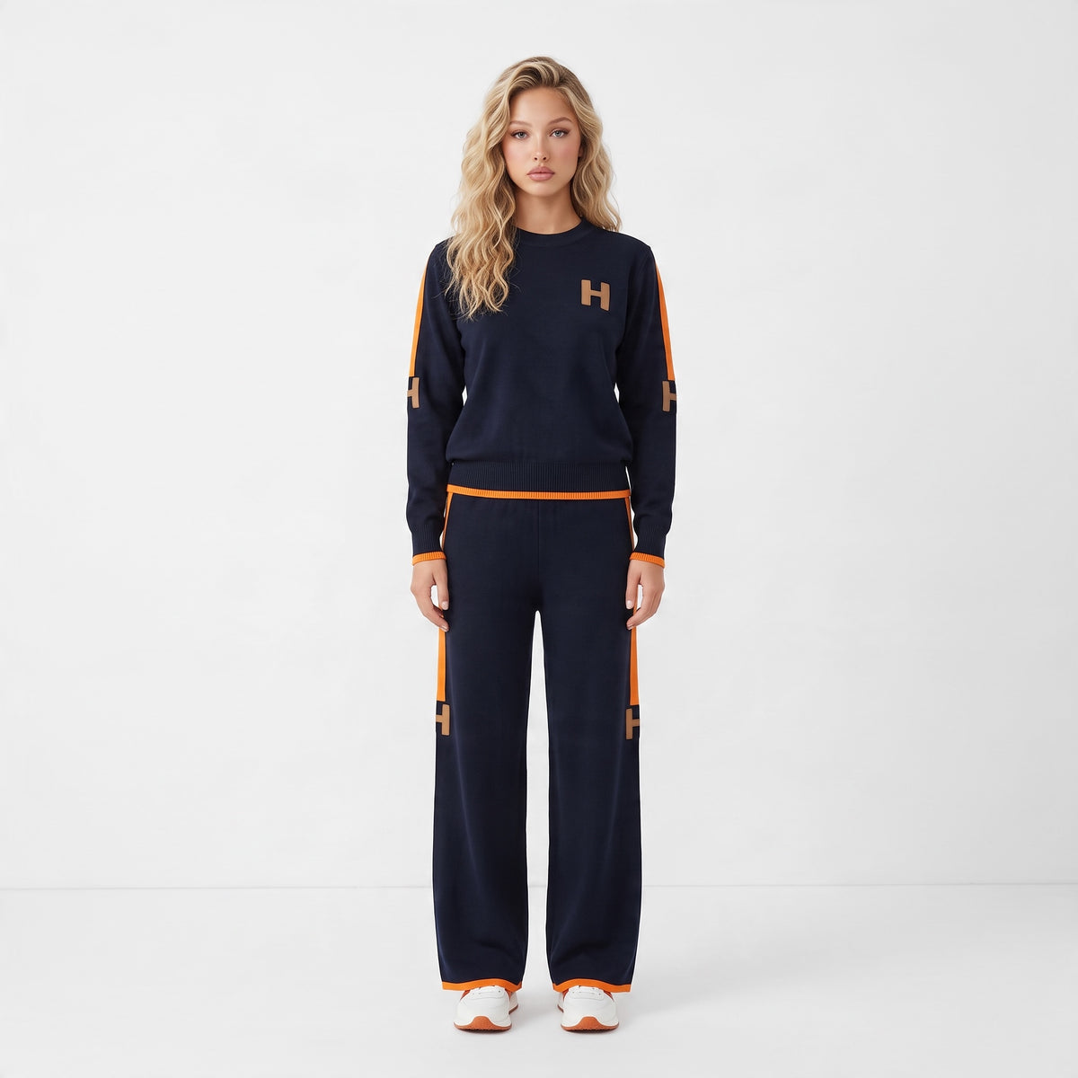 Navy knit crew top and matching wide-leg pants with orange side stripes and H logos