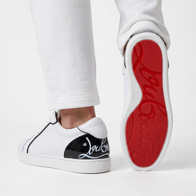 Christian Louboutin white low-top sneakers with black heel tab and red sole