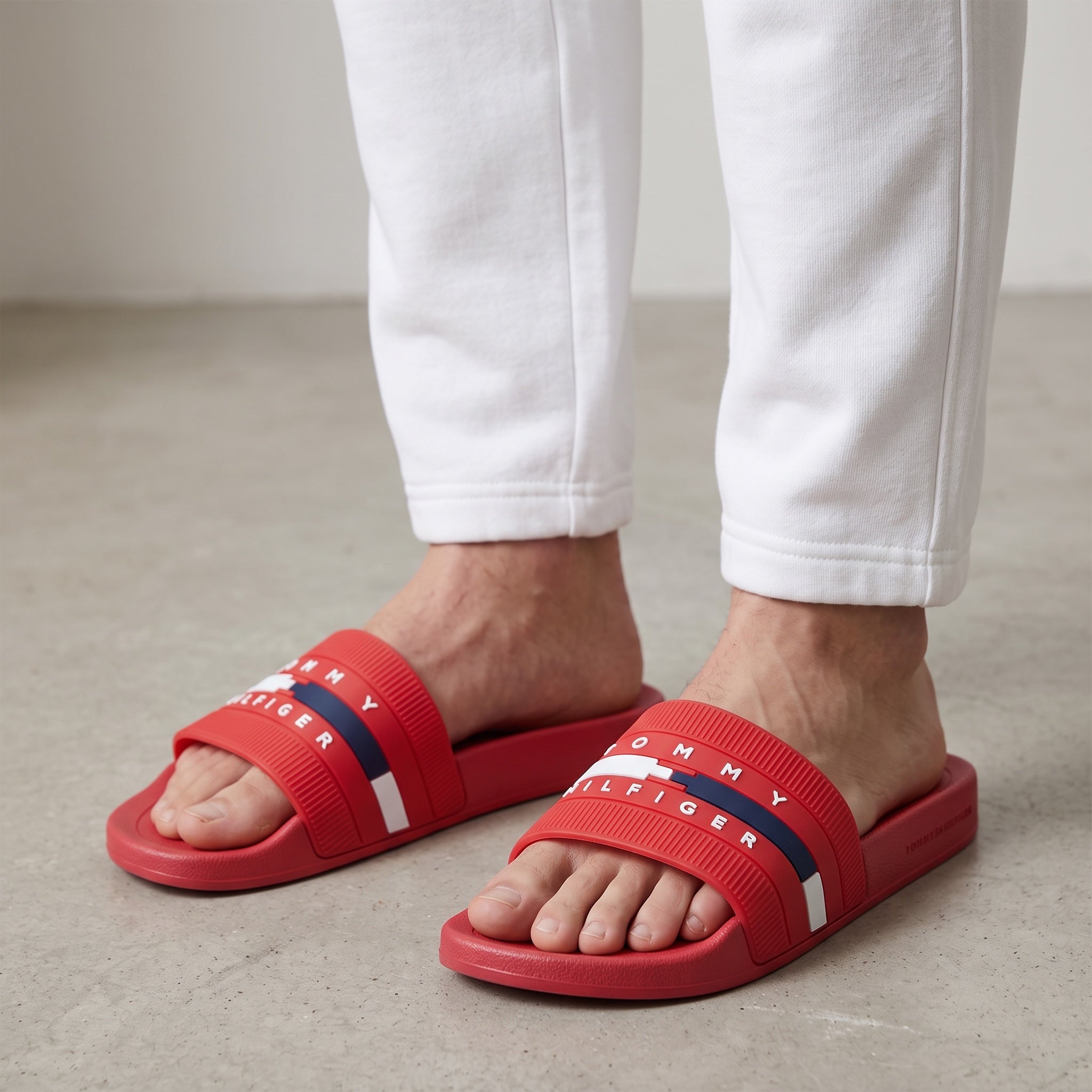 red Tommy Hilfiger slides with navy and white stripe logo on strap