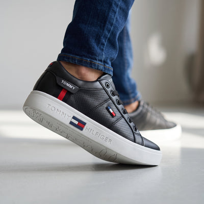 Tommy Hilfiger black low-top court sneakers with white cupsole and flag detail