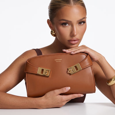Ferragamo tan leather bag with gold Gancini hardware and visible Made in Italy logo