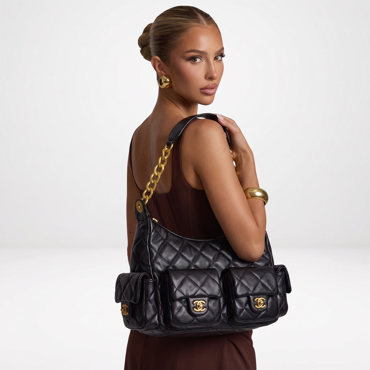 Black quilted Chanel shoulder bag with gold chain and multiple flap pockets