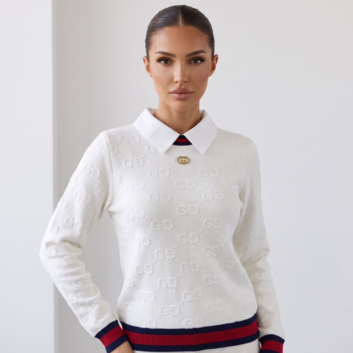 Cream white Gucci knit sweater with polo collar, gold double‑G button and navy-red ribbed hem