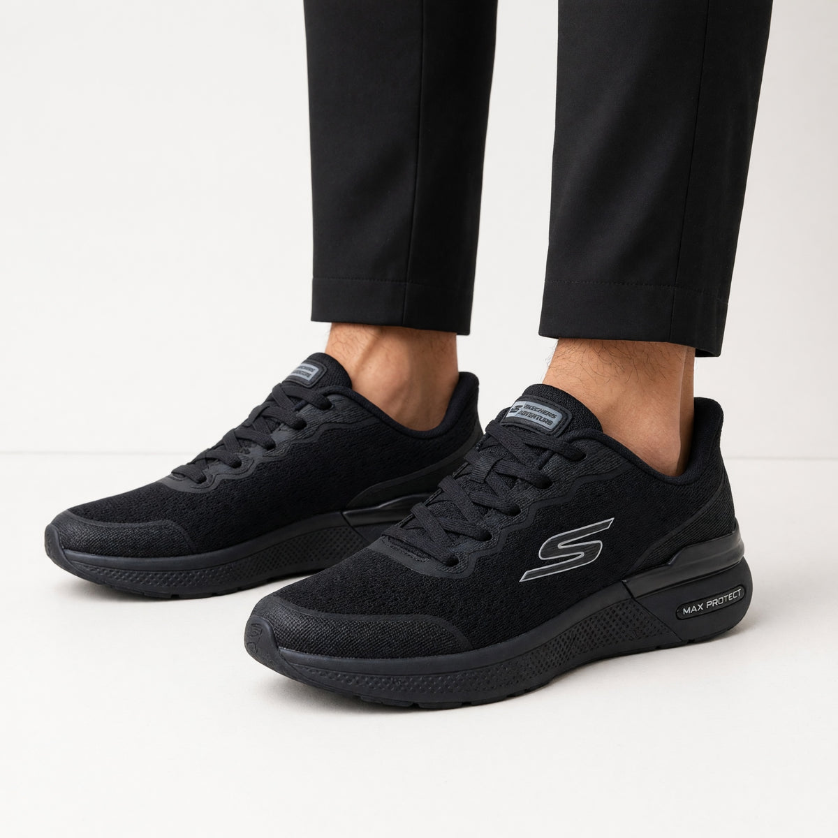All‑black Skechers low‑top sneakers with Max Protect sole