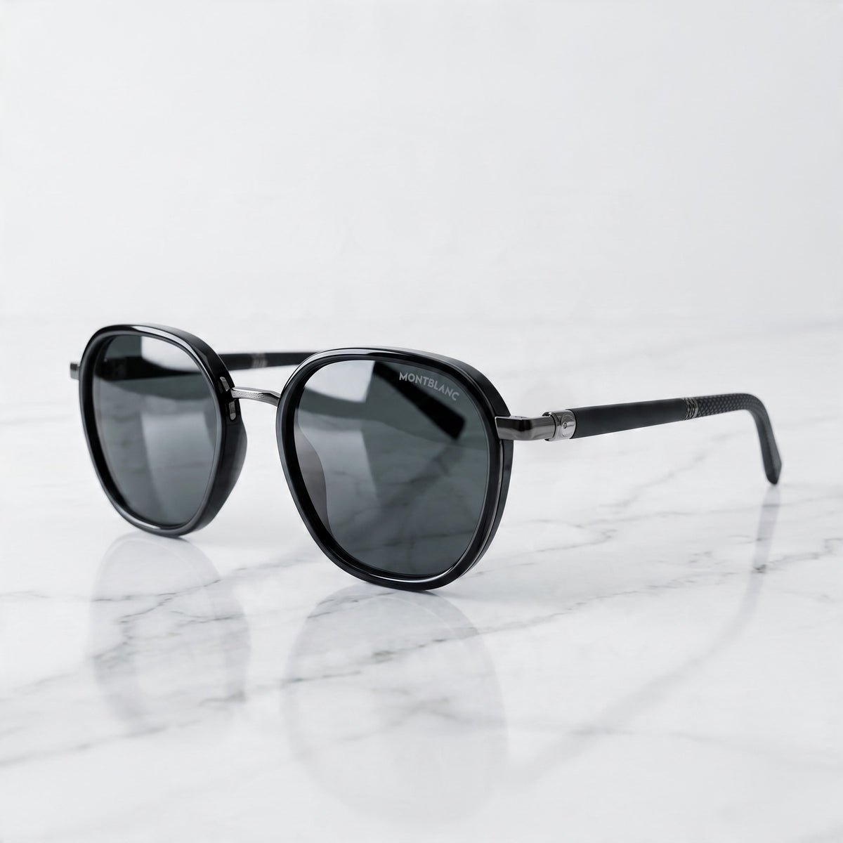 Montblanc black round sunglasses with dark lenses and metal bridge.
