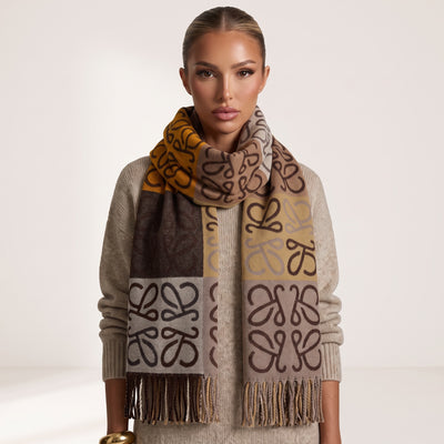 Brown and mustard Loewe anagram logo scarf with fringed ends wrapped around model