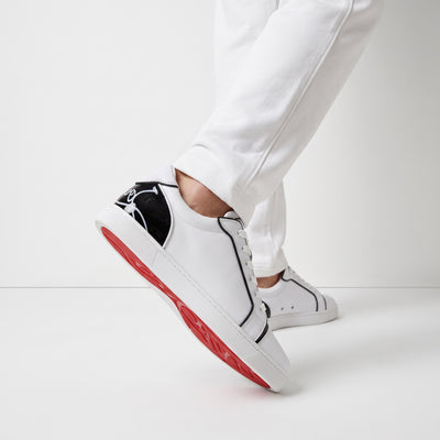 Christian Louboutin white low-top sneakers with black heel tab and red sole