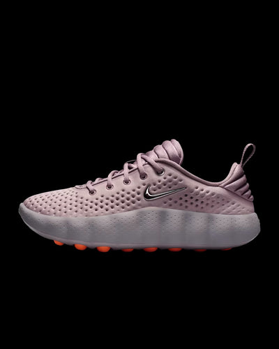 dusty pink nike sneaker with perforated upper and orange pod outsole