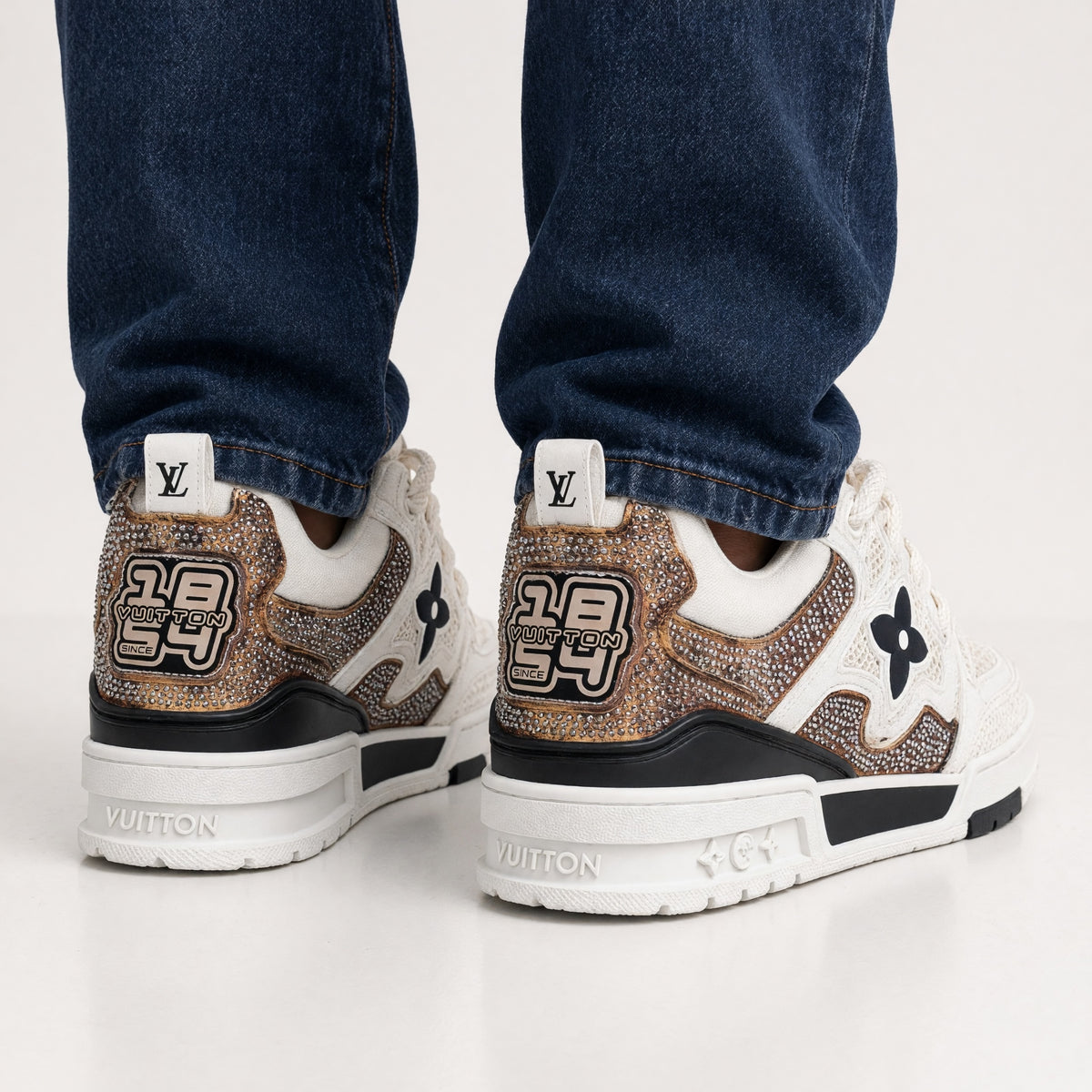 White Louis Vuitton chunky trainer with mesh panels and crystal-embellished copper accents