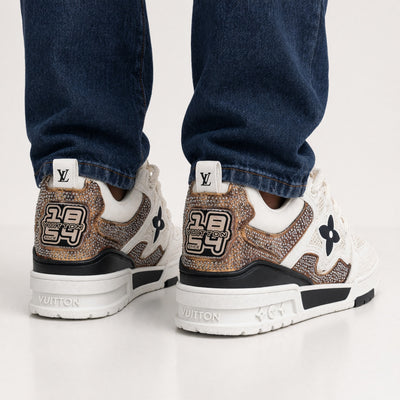 White Louis Vuitton chunky trainer with mesh panels and crystal-embellished copper accents
