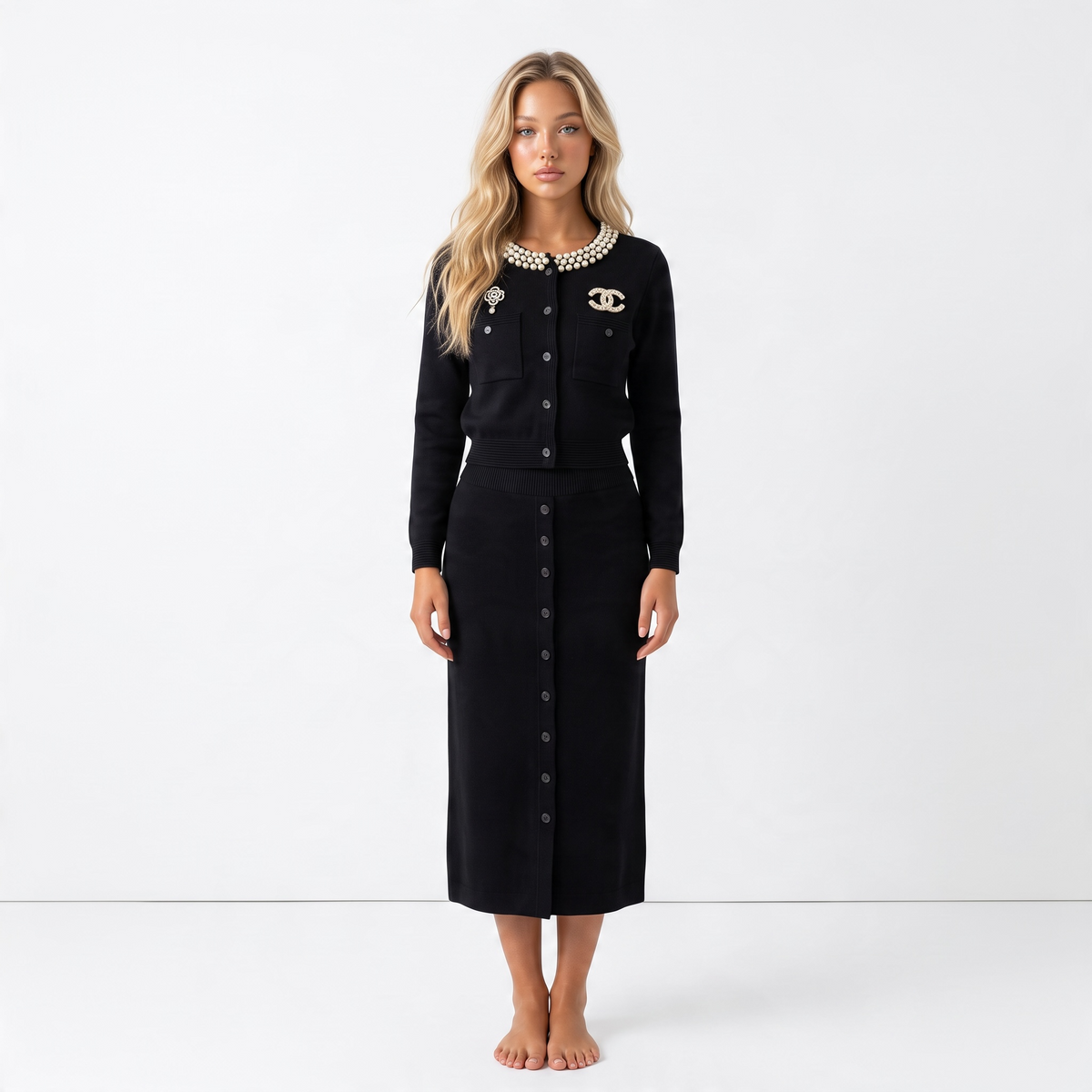 black Chanel cardigan with pearl collar and decorative brooches