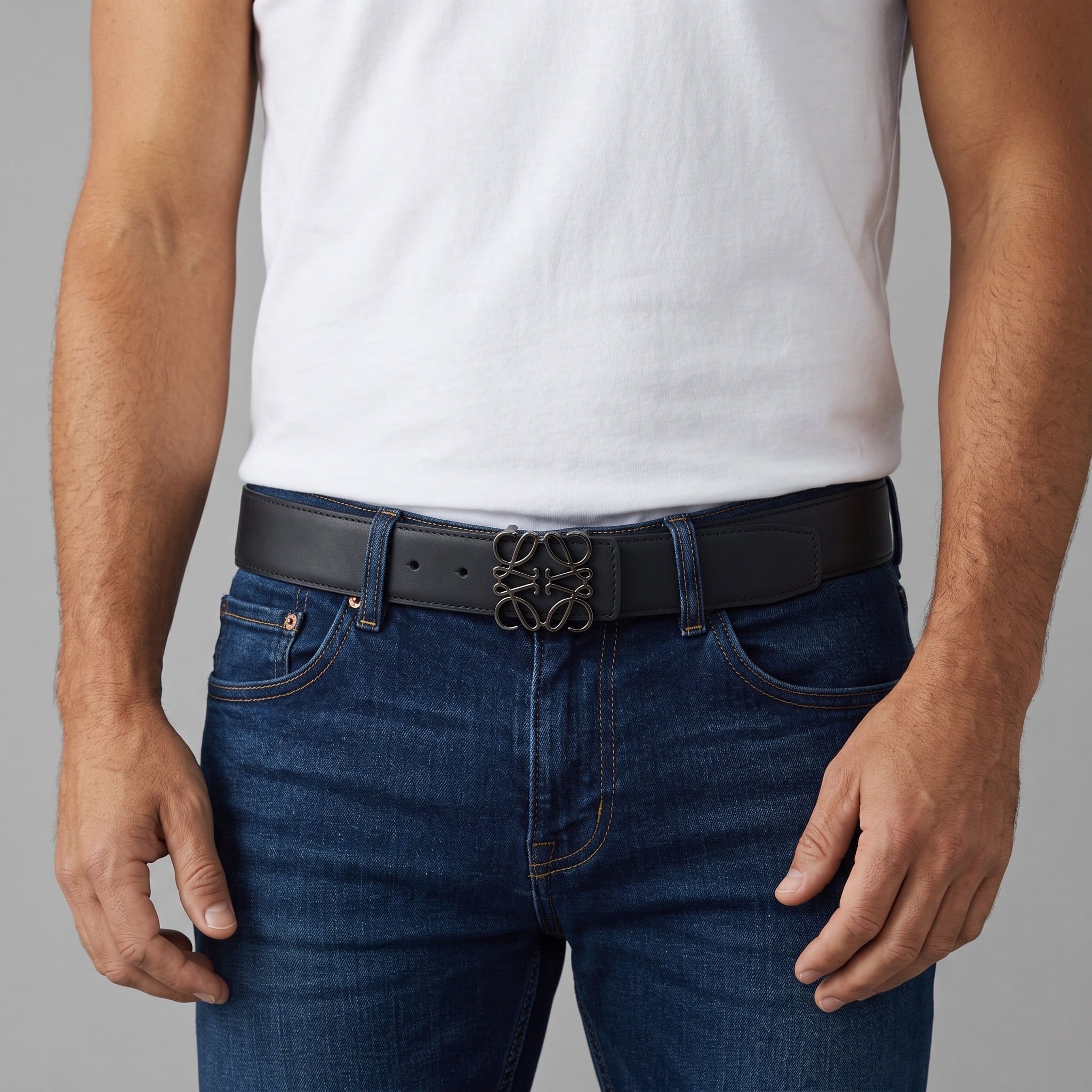 Black Loewe belt with signature anagram metal buckle worn with jeans