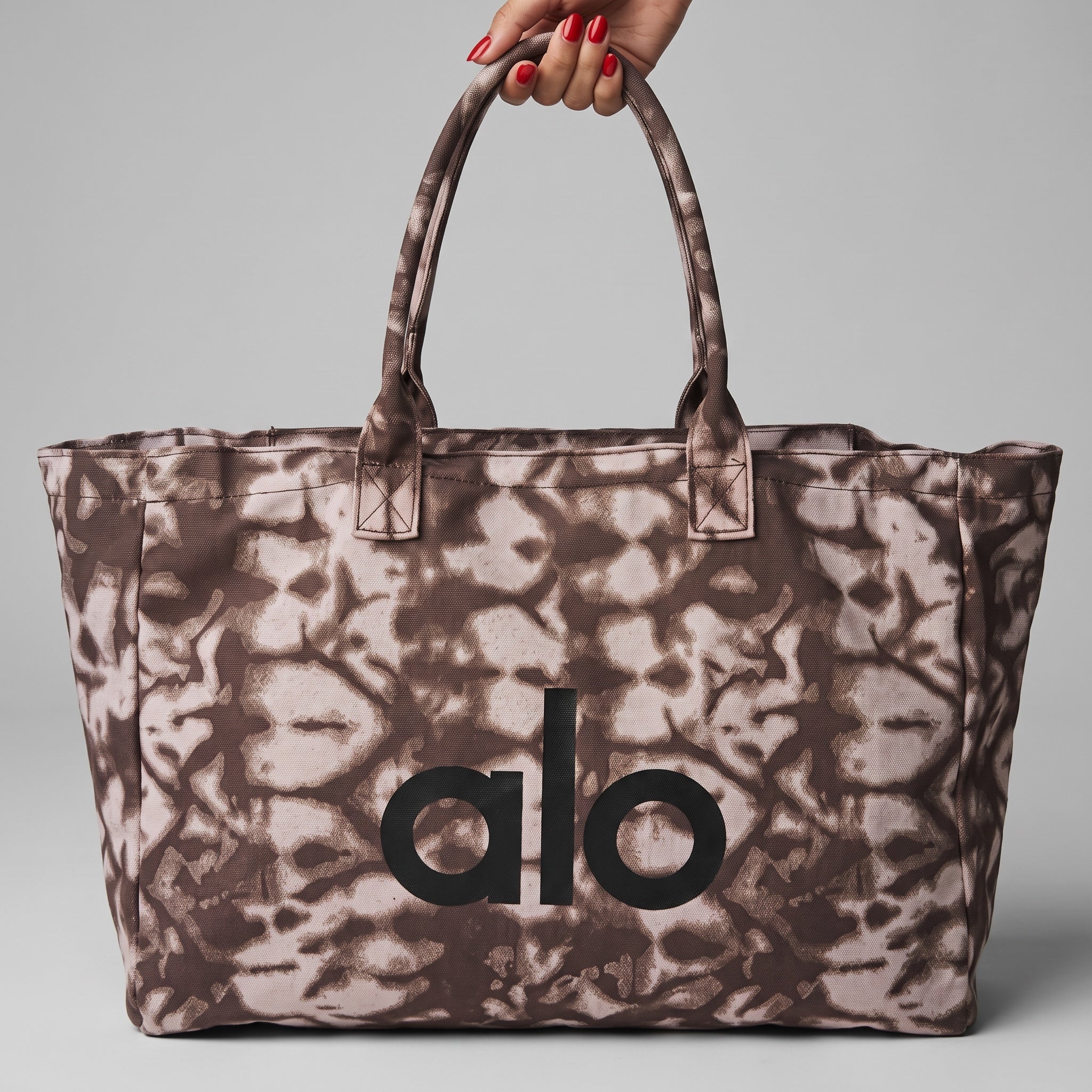 brown tie-dye printed Alo tote bag with top zip and handles