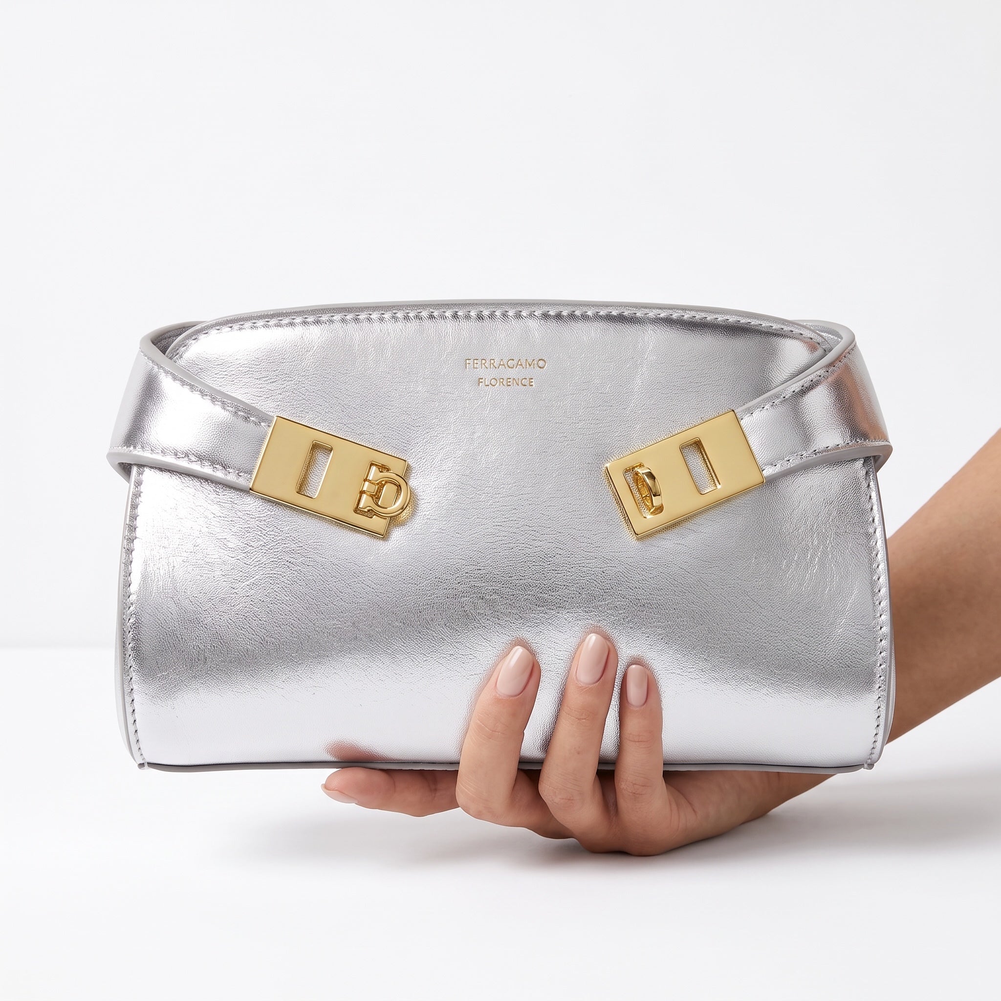Silver Ferragamo mini bag with gold Gancini hardware and metallic finish