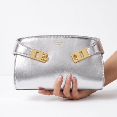 Silver Ferragamo mini bag with gold Gancini hardware and metallic finish